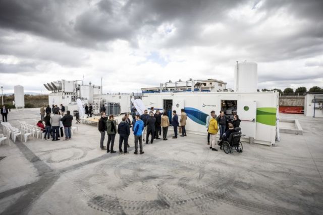 People milling about Climeworks' new plant in Troia, Italy.