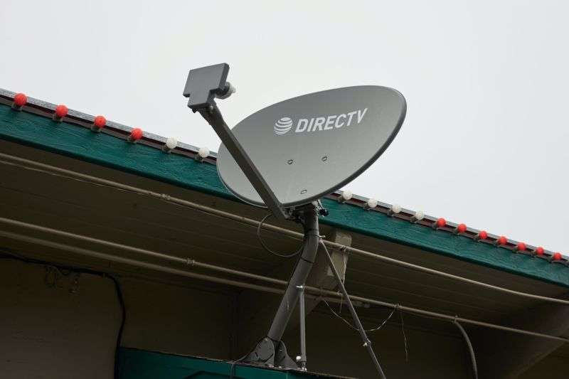 A DirecTV satellite dish mounted to the outside of a building.