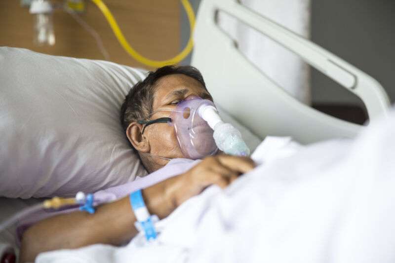 Old woman with Ventilator mask on Hospital bed