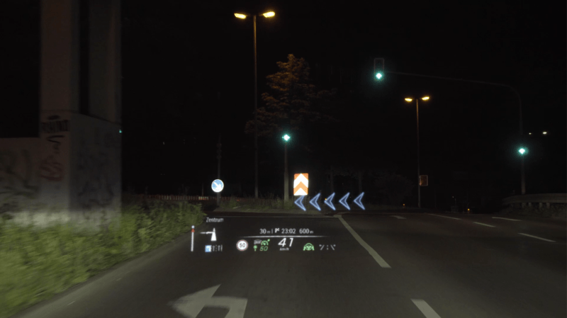 An example of what the Mercedes-Benz augmented reality HUD looks like in action. You can see here it's showing the driver they need to take a left turn.